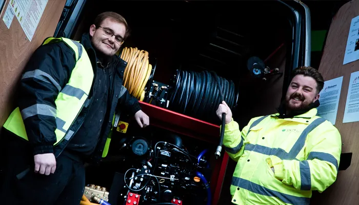 Engineers in high-visibility jackets standing beside drainage equipment in a service van, highlighting Environ Drainage Services' professional team and emergency drainage solutions in London.