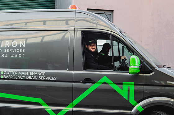 Environ Drainage Services van with two engineers inside, showcasing emergency drain services and maintenance for stadiums.
