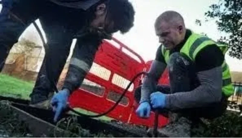 Accredited drainage inspector conducting a CCTV survey of a drainage pipe, highlighting quality assurance in inspections
