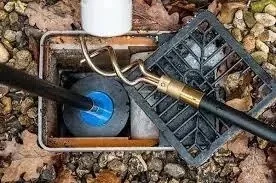 Homeowner performing routine maintenance on drainage systems in a garden setting3